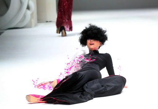 Model Does A Naomi Campbell as she dramatically falls during French Couture Singapore Fashion Show